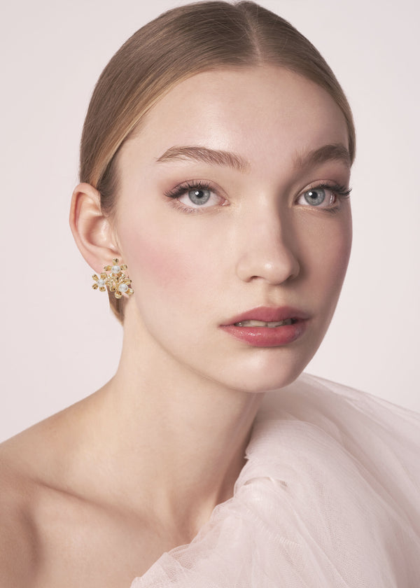 Gold floral pearl cluster stud earring on model