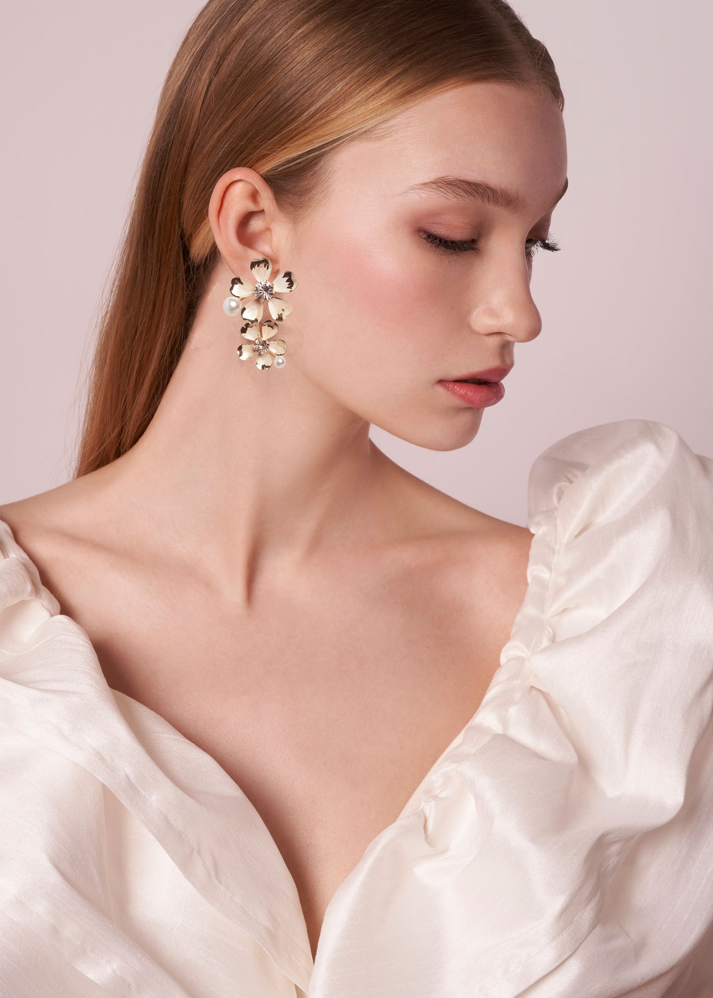 double floral earring in gold on model