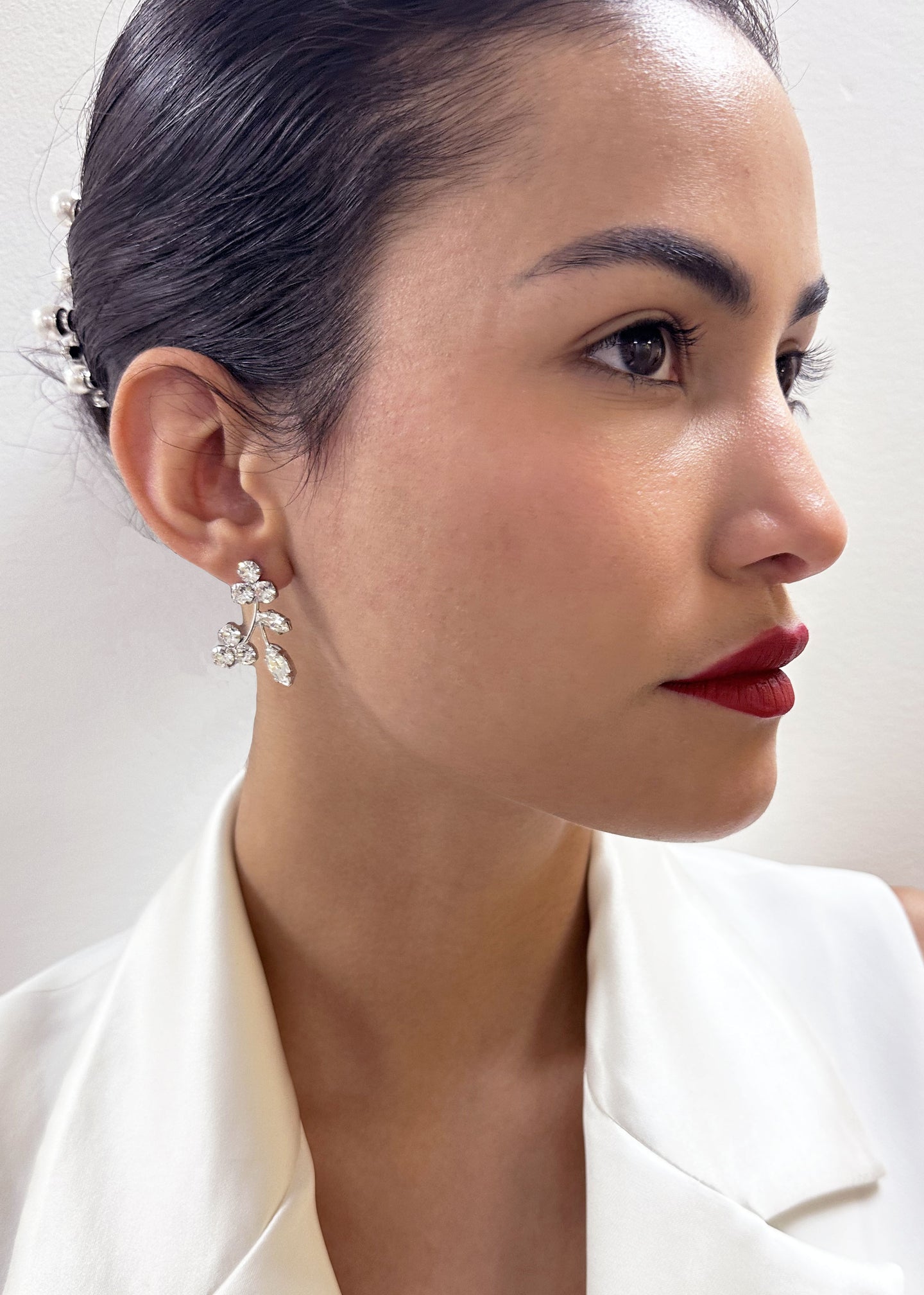 Swarovski crystal floral stud earring on model with red lipstick side view