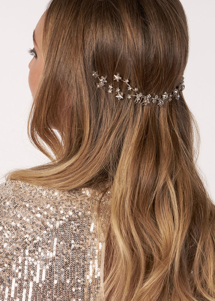 Starry crystal garland bridal hairpiece on model in sequin dress (side view)