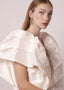 Mother of pearl and crystal mini statement stud earring in left right design on model