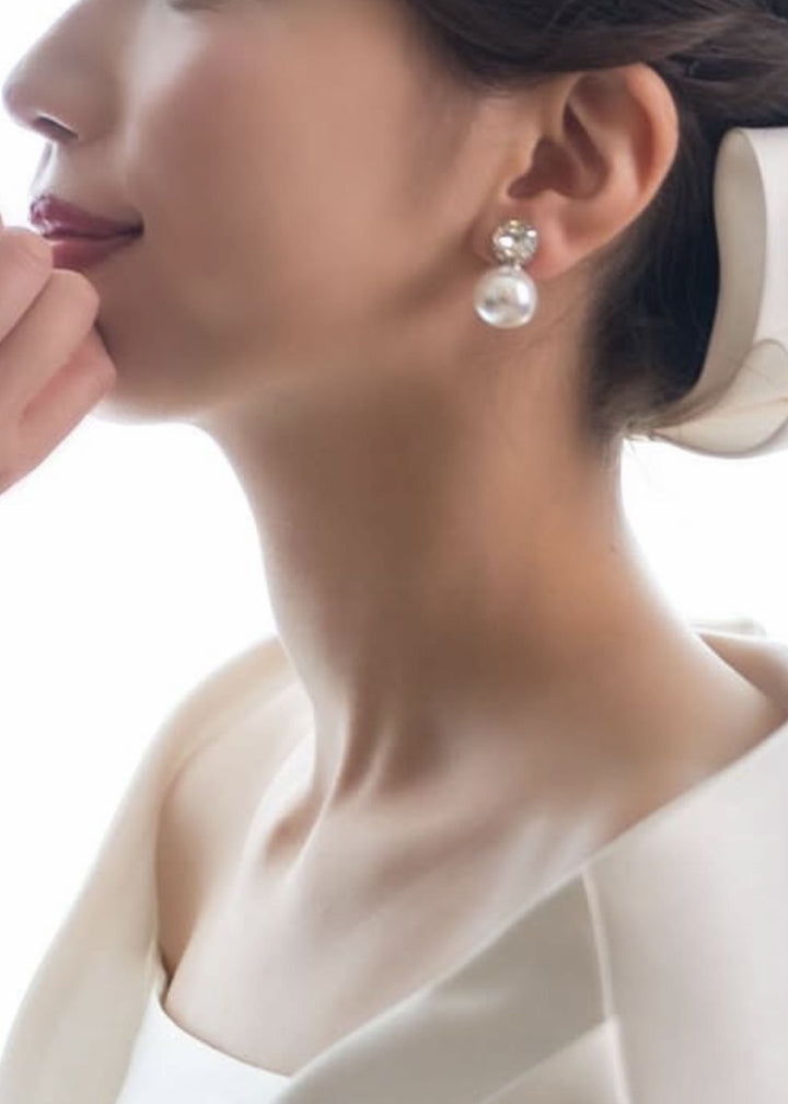Pearl and crystal bridal stud earring on bride (close up side view)