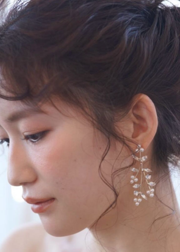 Pearl and crystal mini chandelier earring on bride (side view)