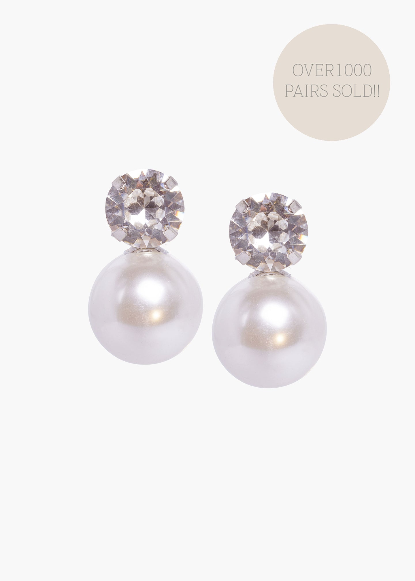 Pearl earrings with crystal accents on a white background