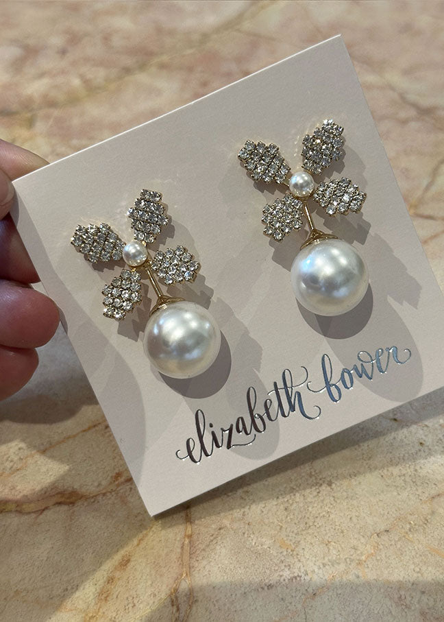 Swarovski crystal and gold pearl bridal stud earring on grey ear card