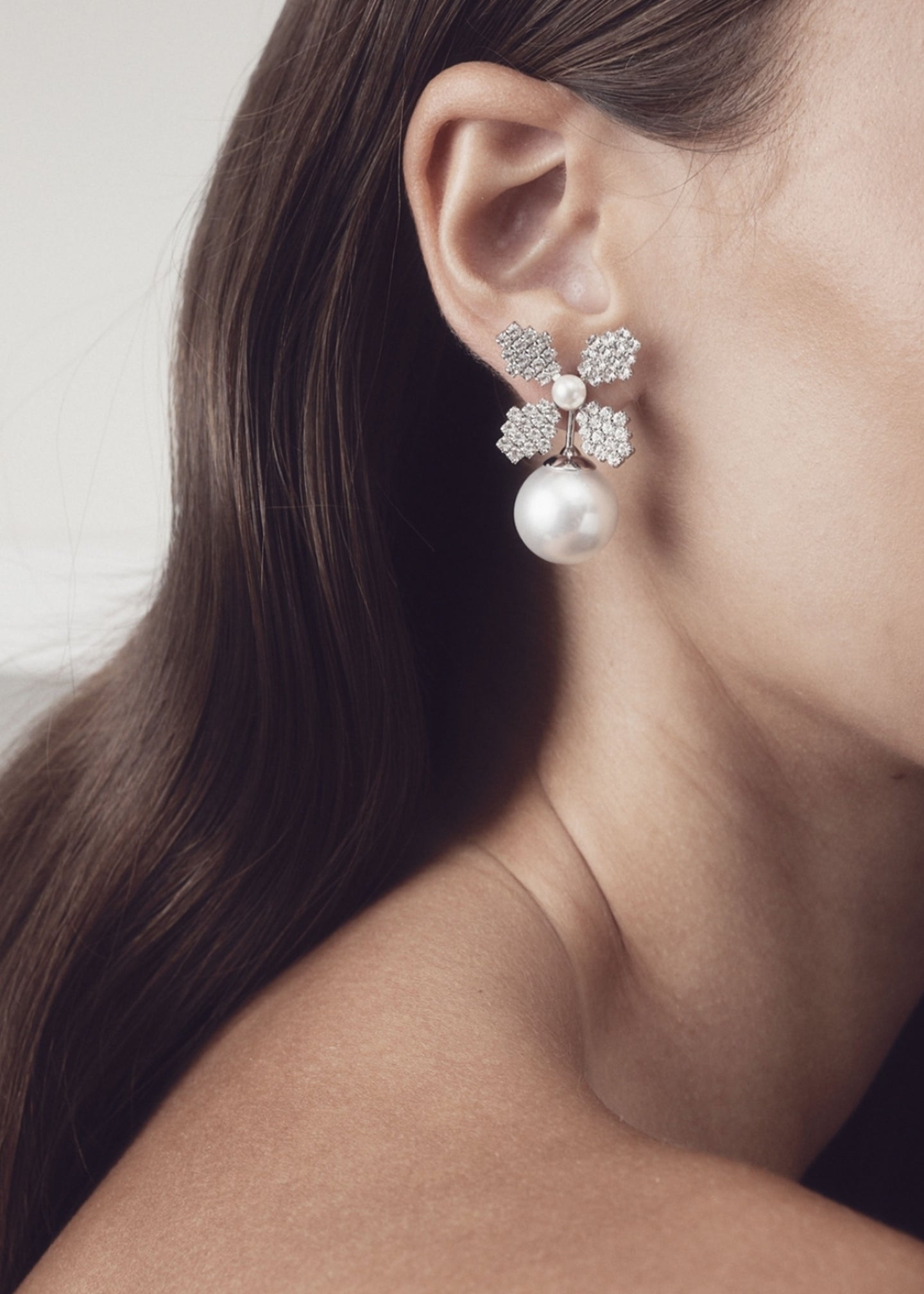 Swarovski crystal and pearl bridal stud earring on model close up side view