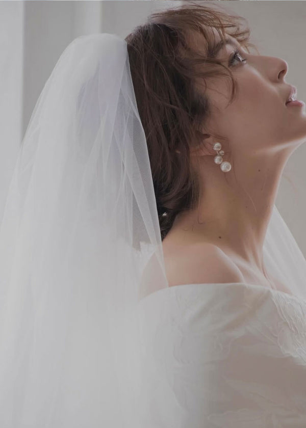 clustered pearl stud earring on model in veil side view