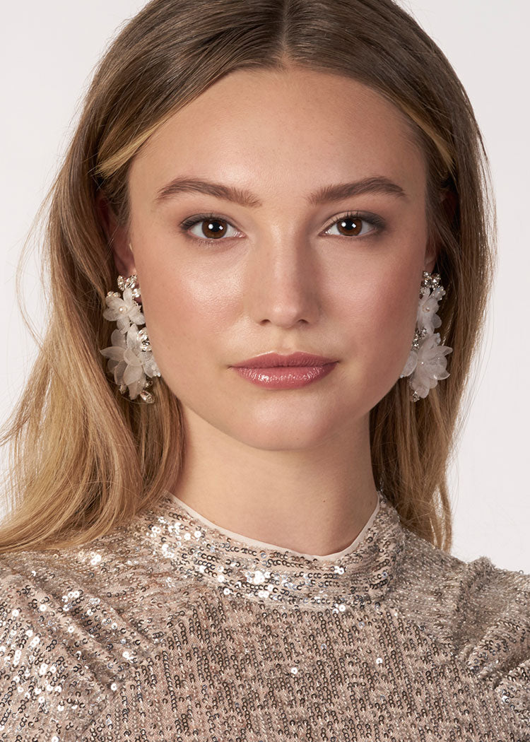 ivory floral chandelier earring made with silk flower, crystals and pearls on model (front view)