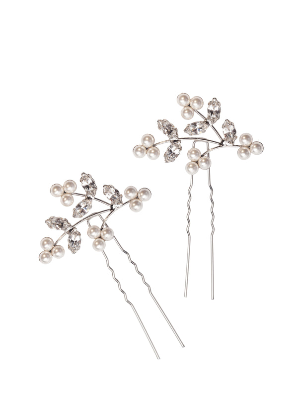 A pair or floral pearl wedding hairpins made with crystal accents on a white background