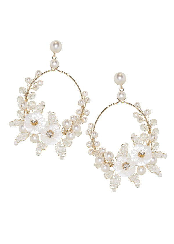 Gold floral pearl hoop earring on white background
