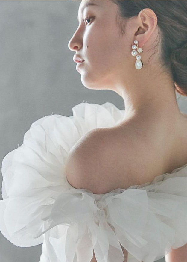 pearl wedding earrings on bride in ruffled wedding dress (side view)