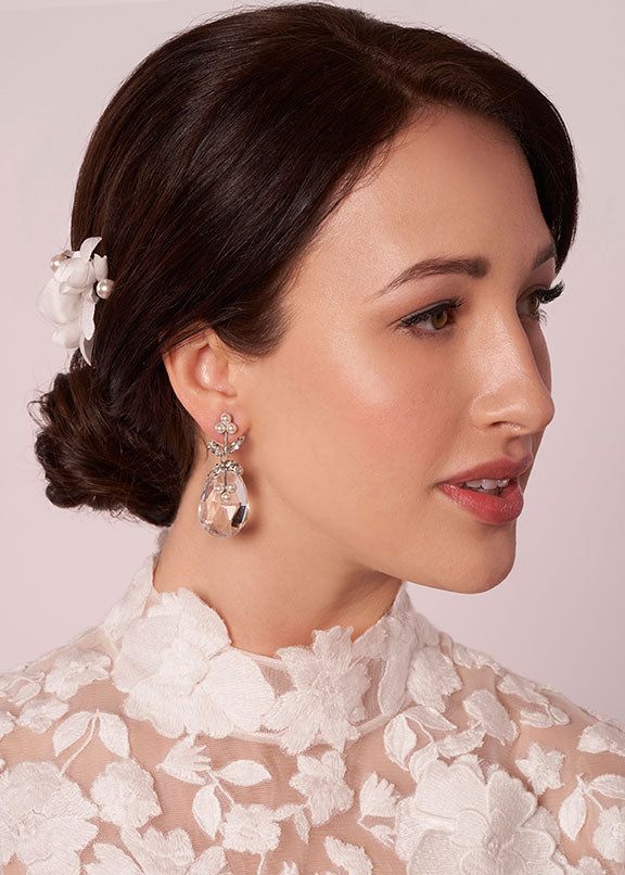 Crystal tear drop earring with pearl accents on model in lace dress (side view)