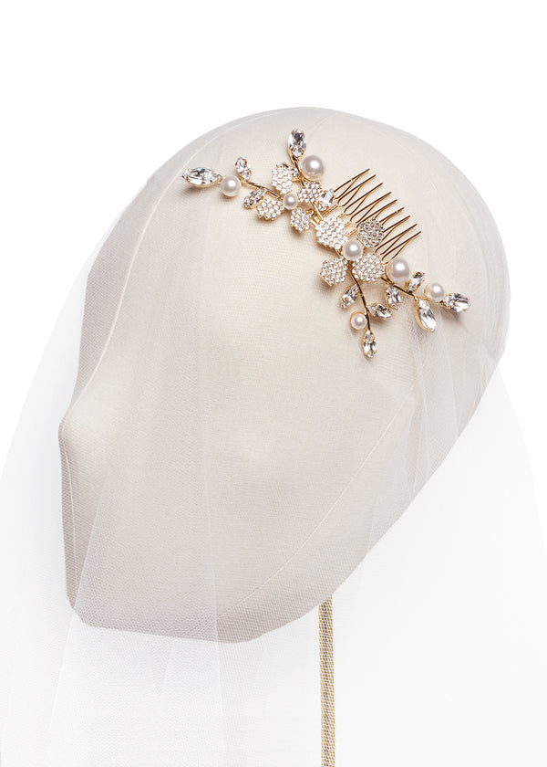 Gold Pearl and crystal floral hair comb on a headstand