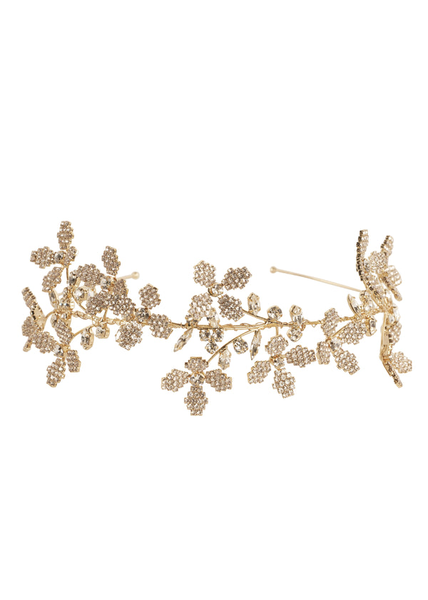 Golden floral bridal hairpiece laid flat on white background