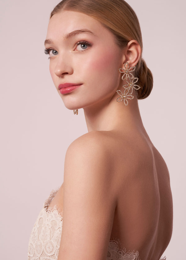 Swarovski crystal floral trio earring in gold on model (side view)