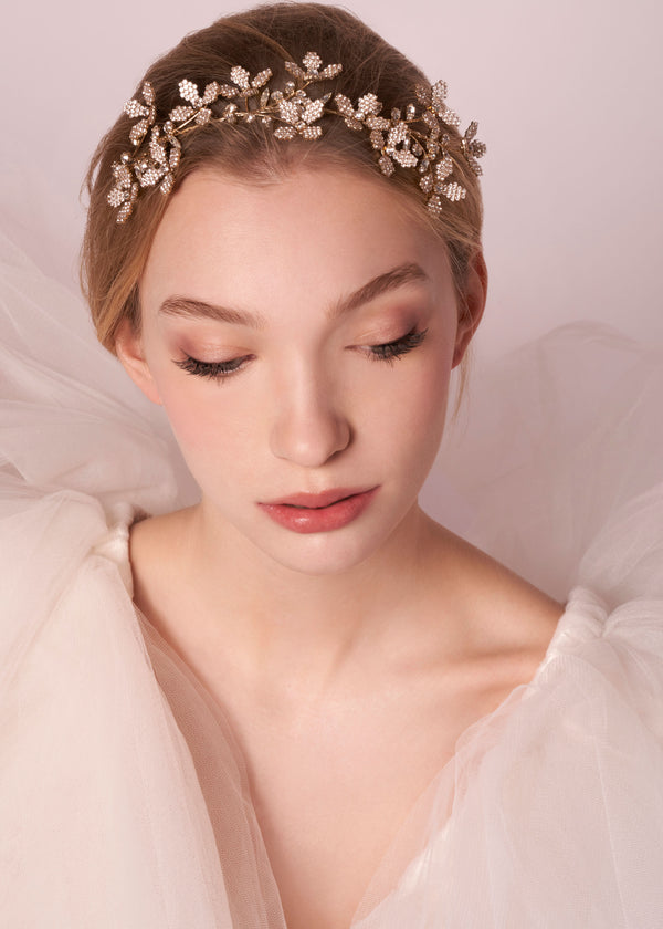 Gold crystal floral hairpiece on mode in tulle dress (portrait)