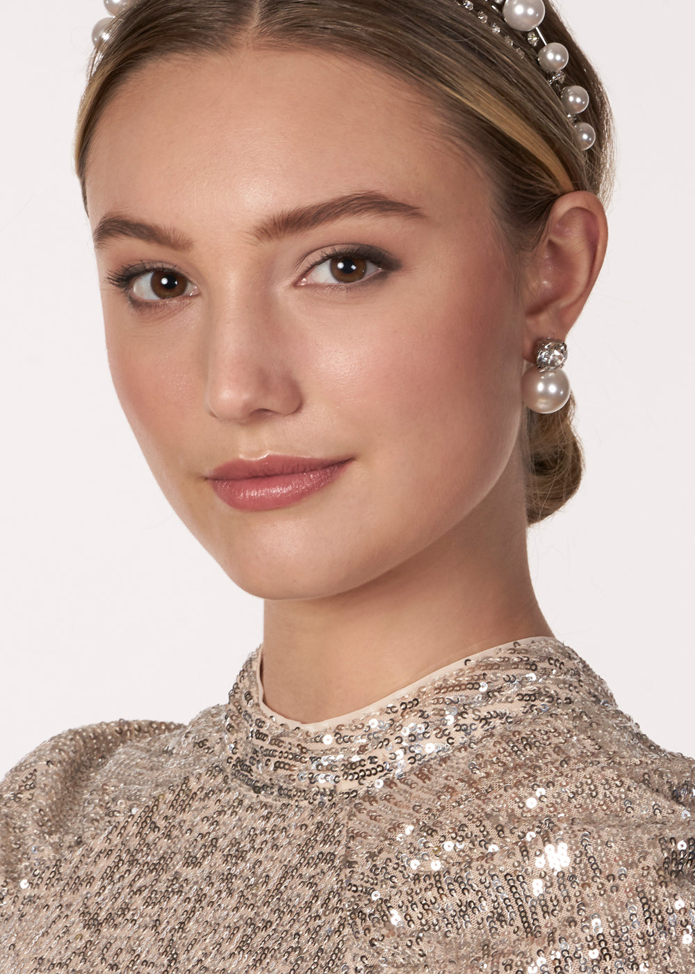 Swarovski crystal and pearl stud silver earring on model in sequin dress front view