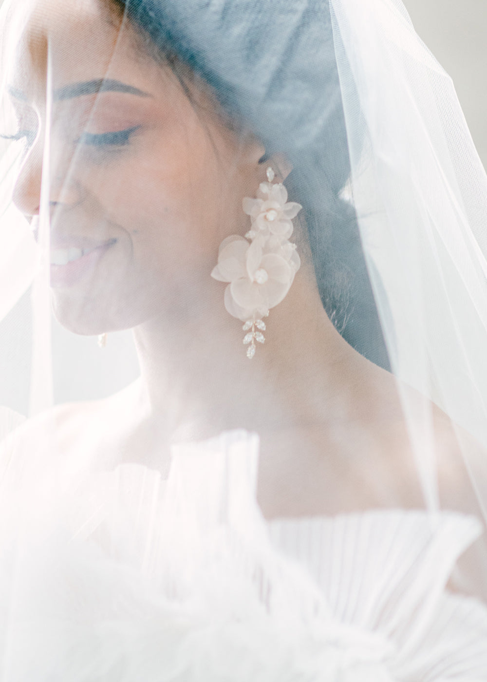 blush silk floral statement earring with Swarovski crystals on Bride in veil