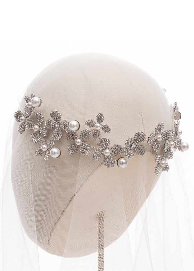 statement floral bridal hairpiece on headstand back view with tulle