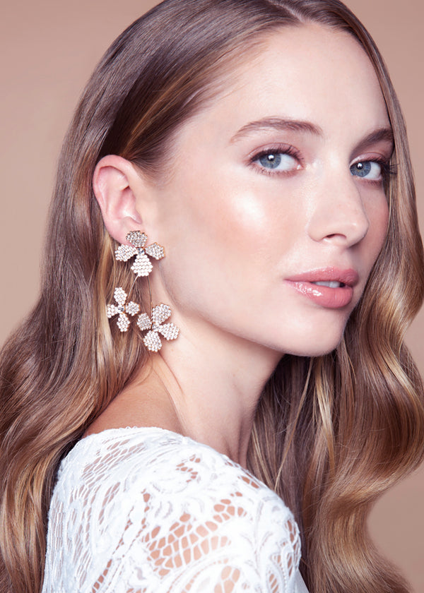 floral Swarovski crystal cascading earring in gold on white background