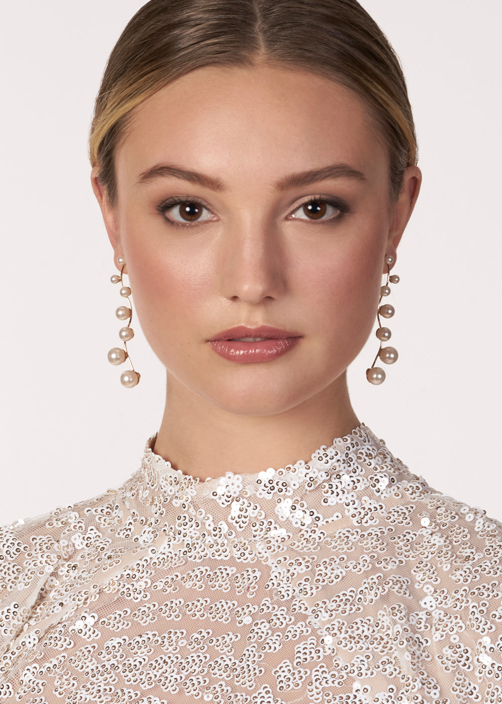 Long scattered pearl drop earring on model front view