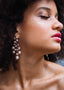 Cascading silver pearl chandelier earring on model close up side view