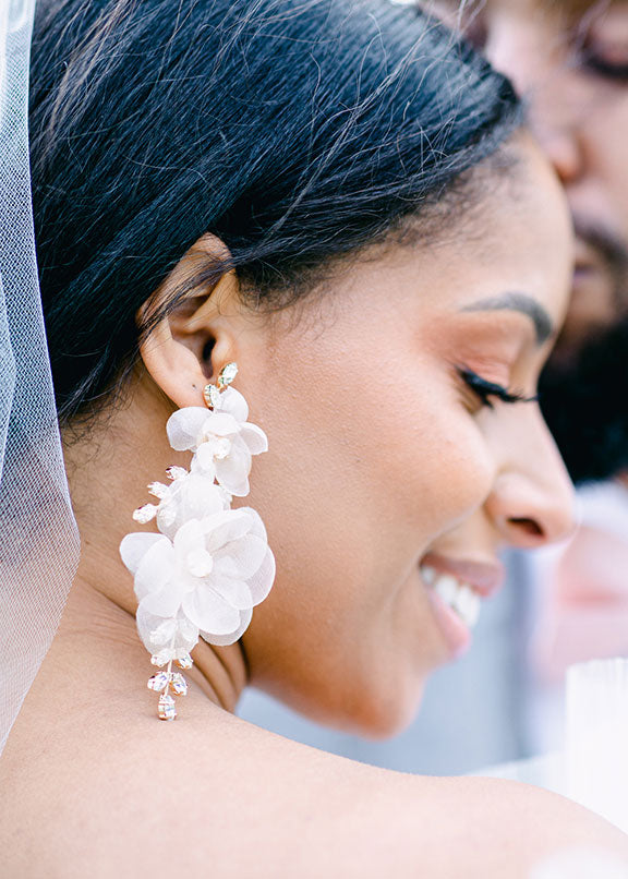 ivory silk floral statement earring with Swarovski crystals on Bride side view close up