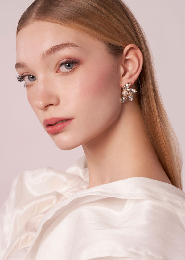 Gold Swarovski crystal and pearl statement stud earring, left right design on model (portrait side view)