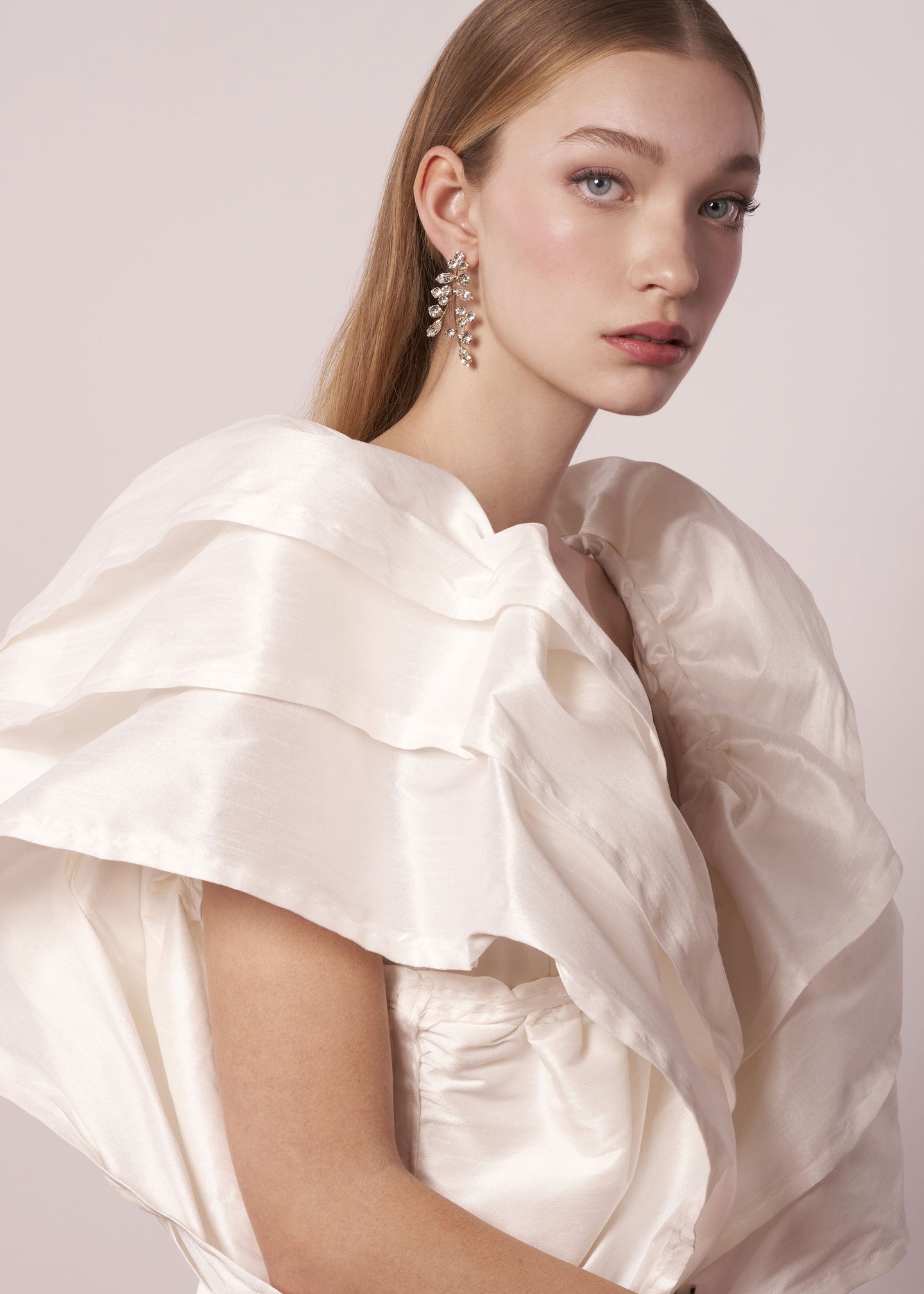 Scattered Swarovski crystal silver statement earring left right design on model in ruffled wedding dress