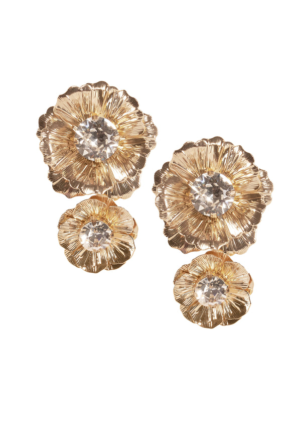 A pair of gold-colored floral statement stud earrings with crystal accents