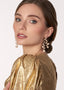Cascading gold pearl chandelier earring on model in gold top side view