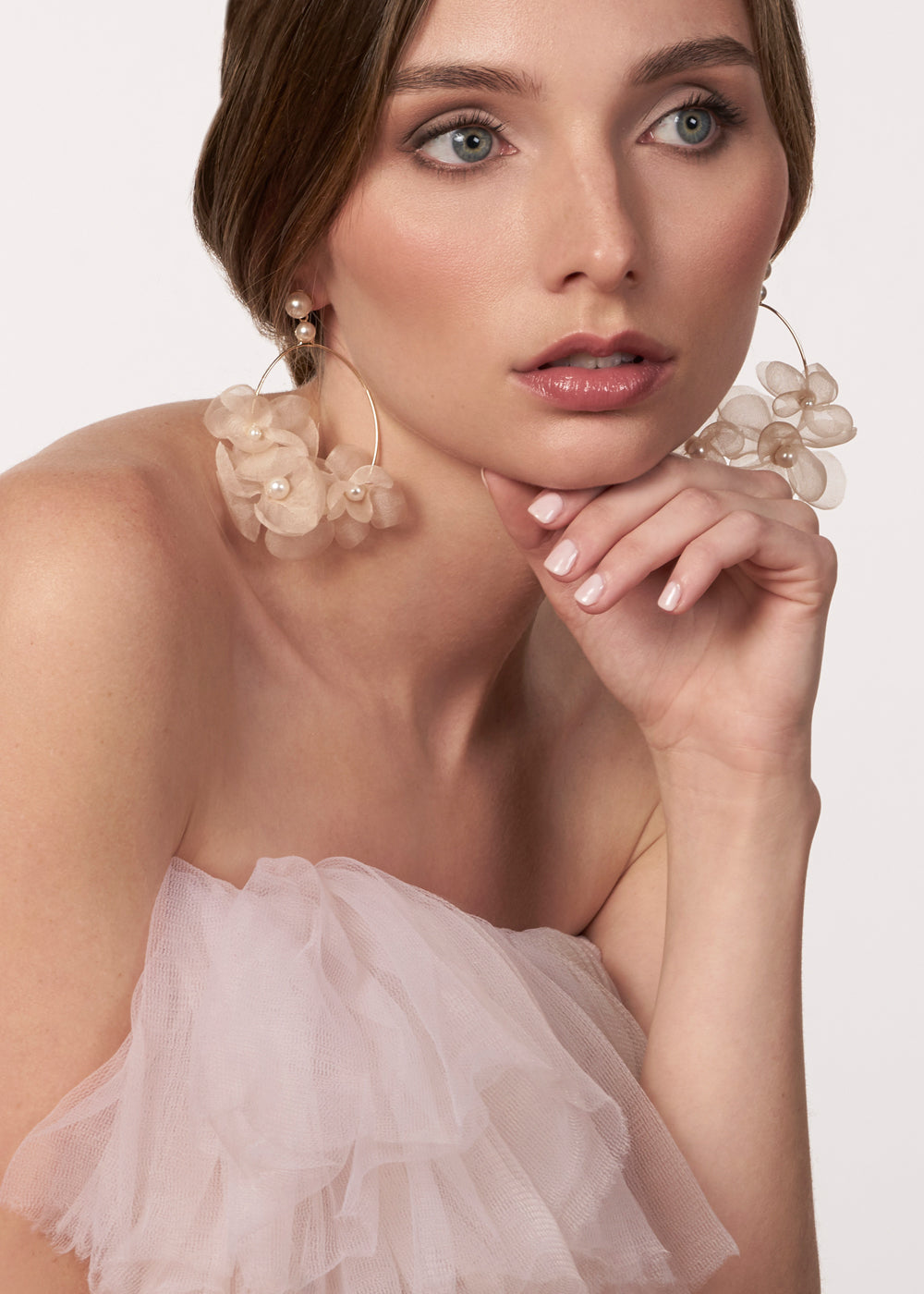 blush silk floral hoop earring with pearl accents on model in blush dress