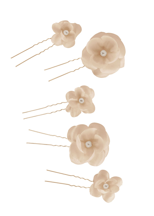 A Set of blush and pearl floral bridal hairpins laid flat on white background.