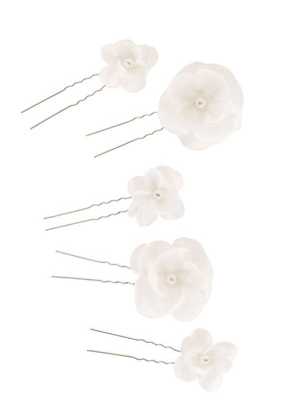 A Set of Ivory and pearl floral bridal hairpins laid flat on white background.