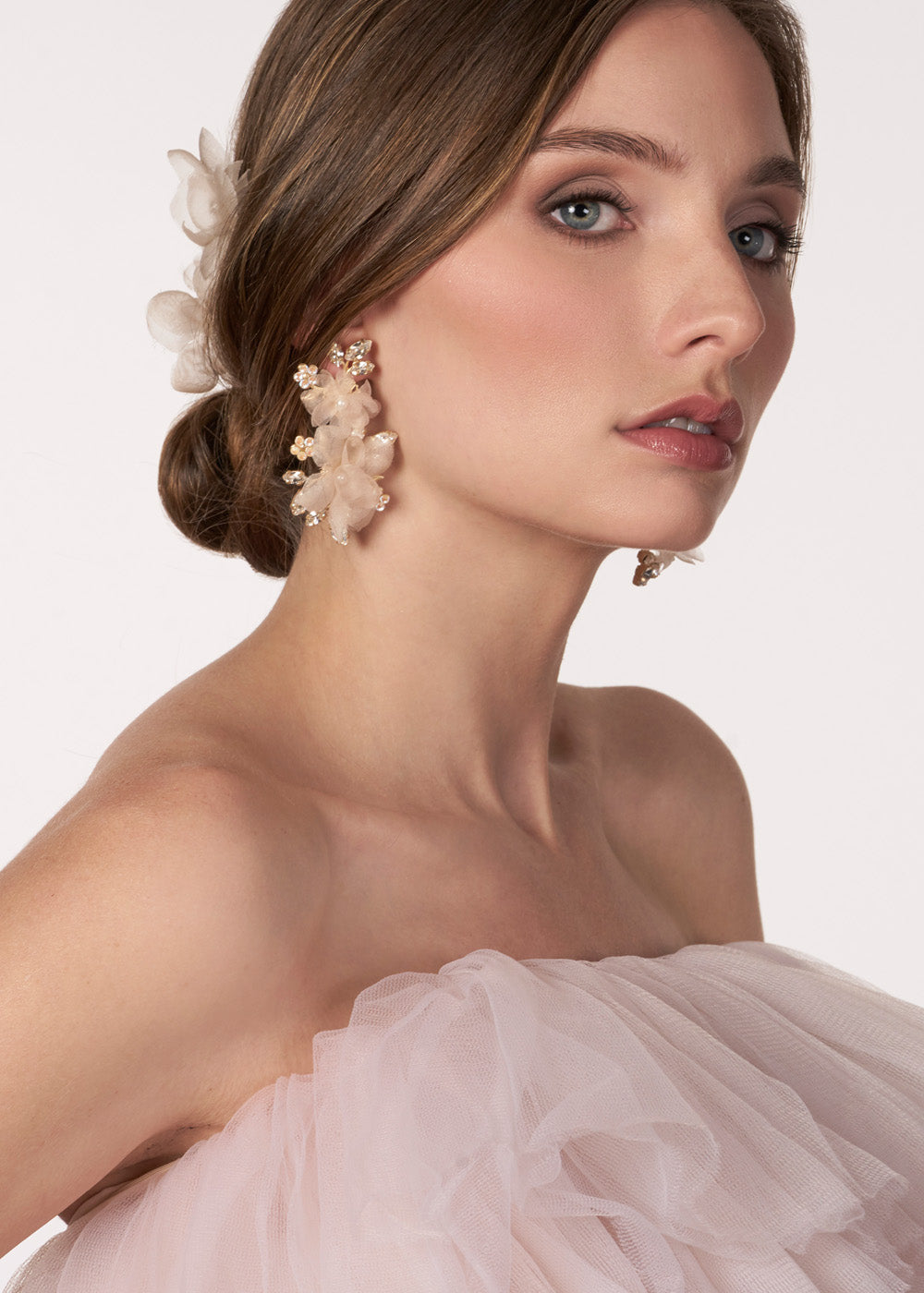 blush floral chandelier earring made with silk flower, crystals and pearls on model side view