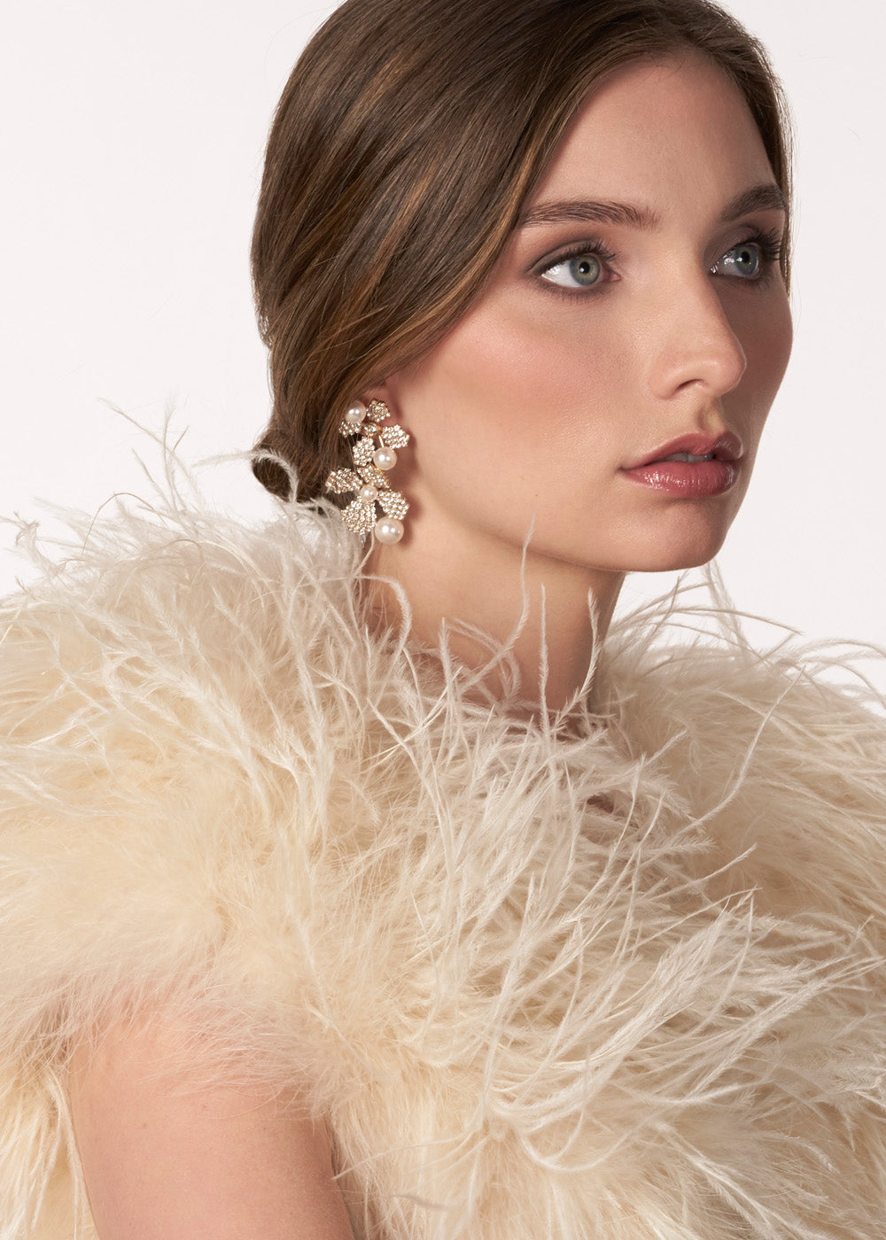 Gold crystal double flower earring with pearl accents on model side view