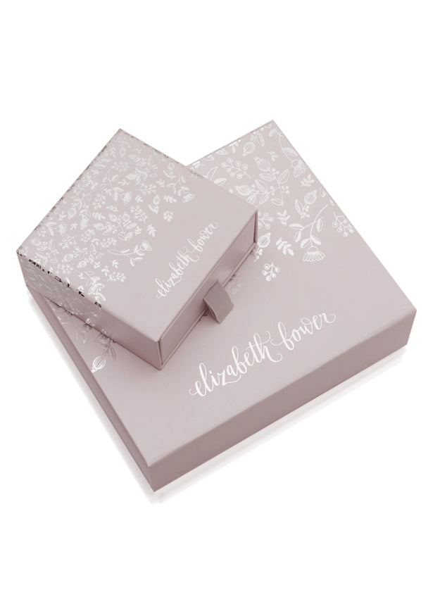 two floral pink gift boxes stacked on top of each other on white background