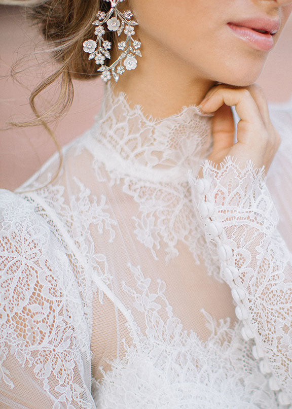 floral earring on model on lace wedding dress
