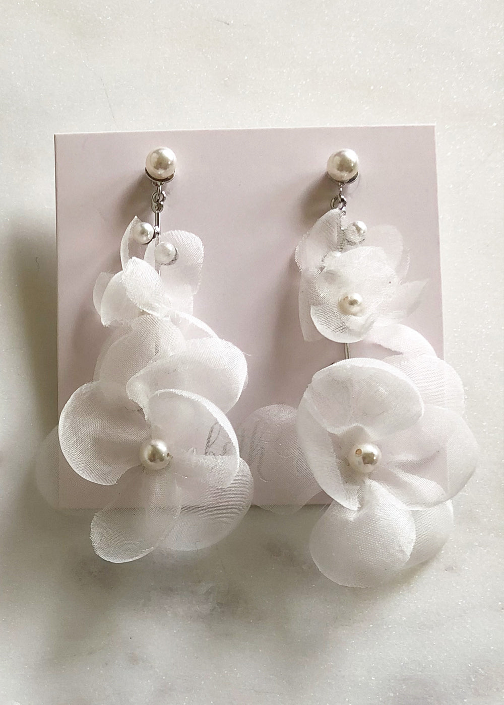 Silk floral drop earring in ivory and silver on pink ear card