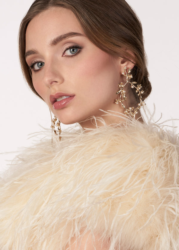 Gold pearl floral hoop earring on model side view