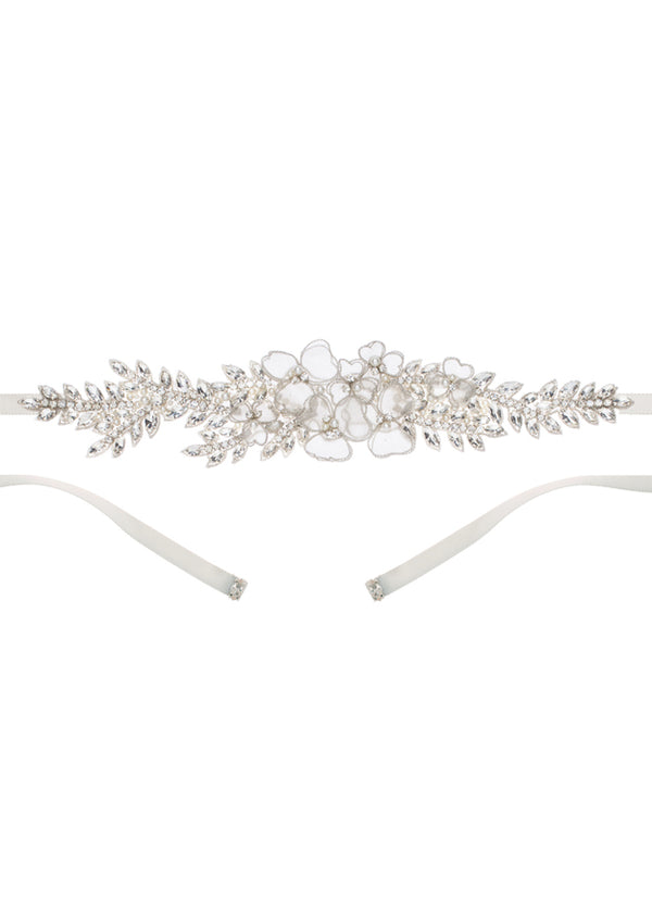A silver floral wedding dress sash laid flat on a white background