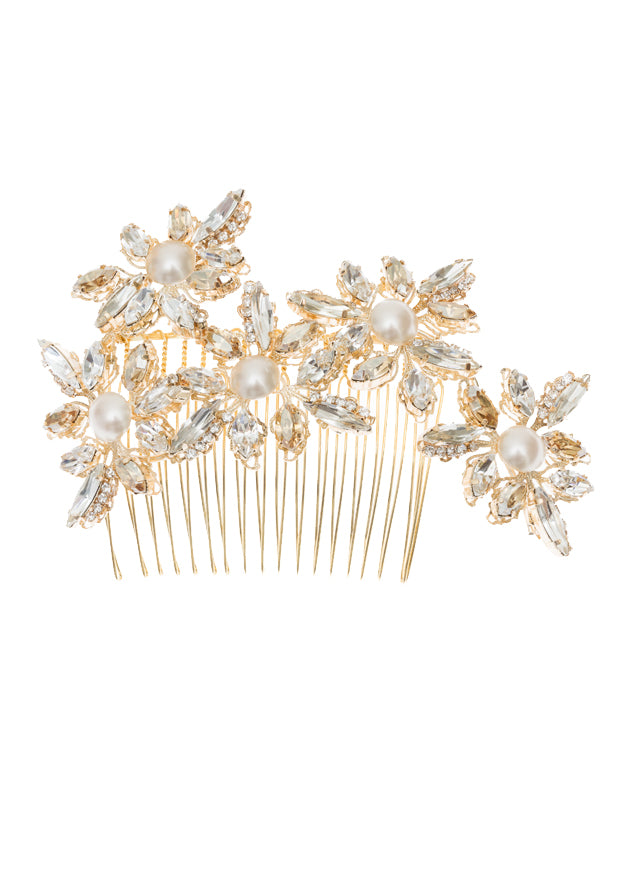 A floral gold statement hairpiece on a white background
