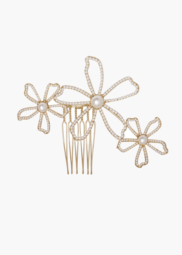 Gold hair comb with floral designs on a white background
