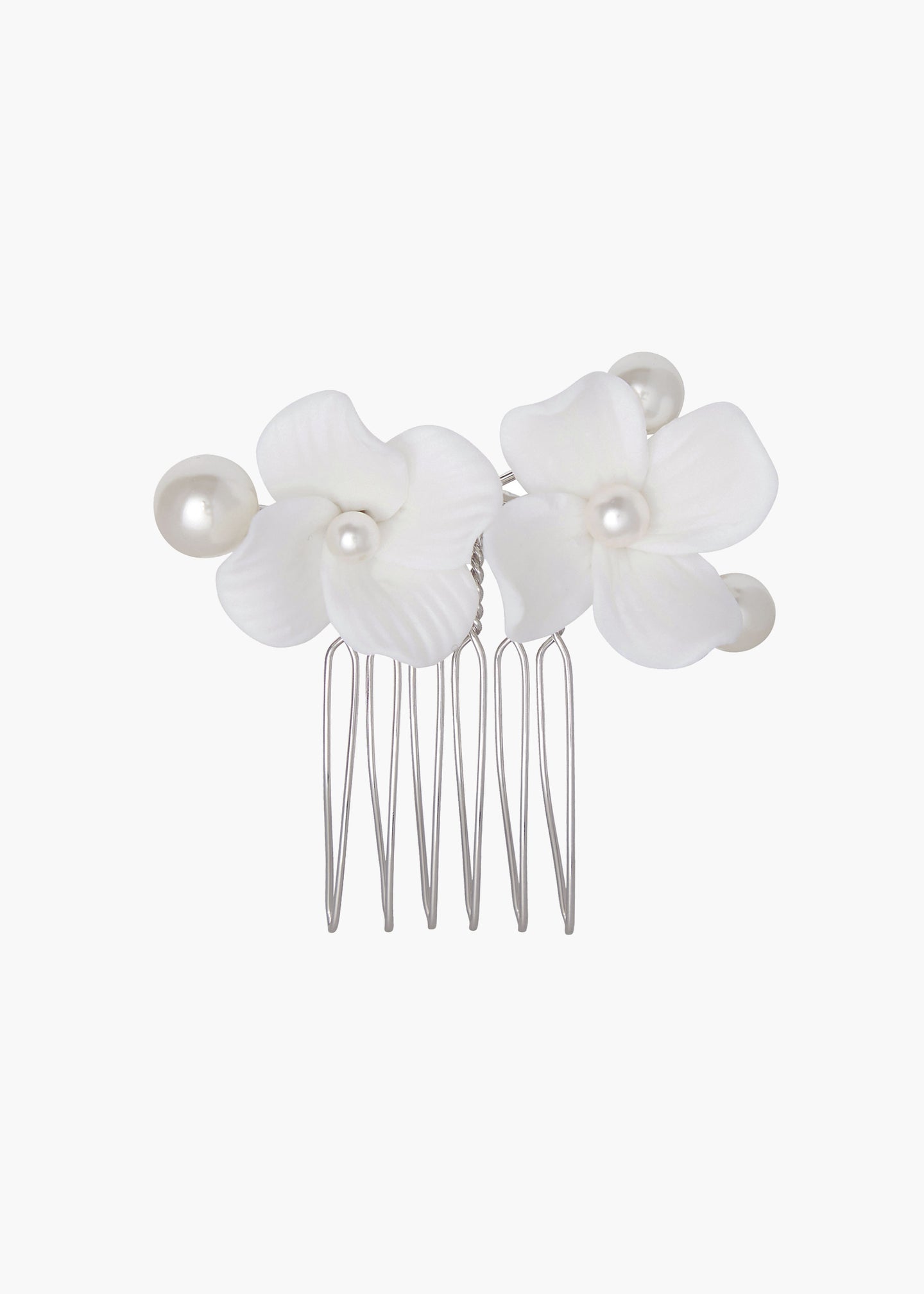 Hair comb with white floral attachments and pearls on a white background