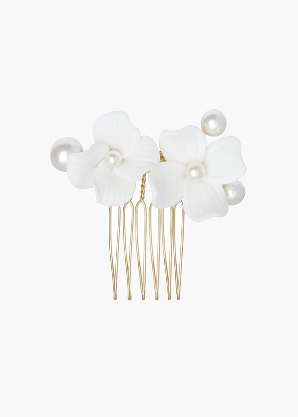 Hair comb with white floral attachments on a white background