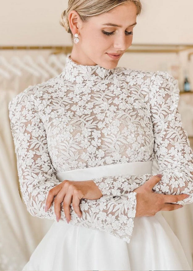 Pearl and crystal stud earring on model in lace dress (arms crossed)
