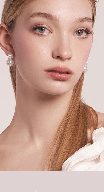 Close up of bride in double pearl earrings