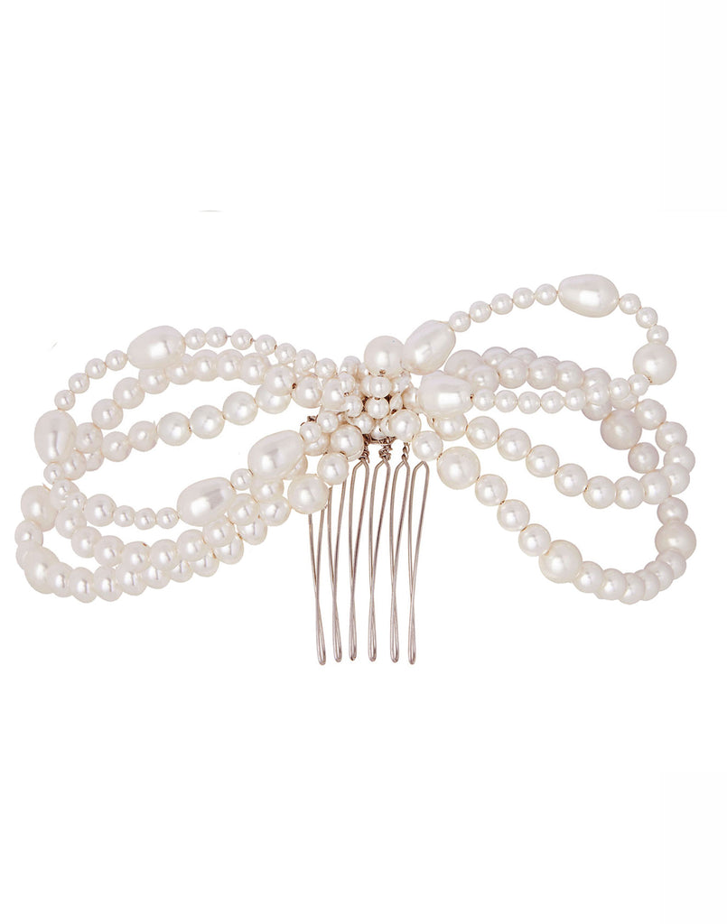 Pearl bow hair comb on white background 