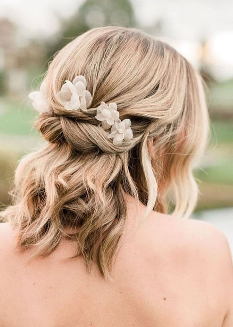 Silk floral hairpins on bride back view 