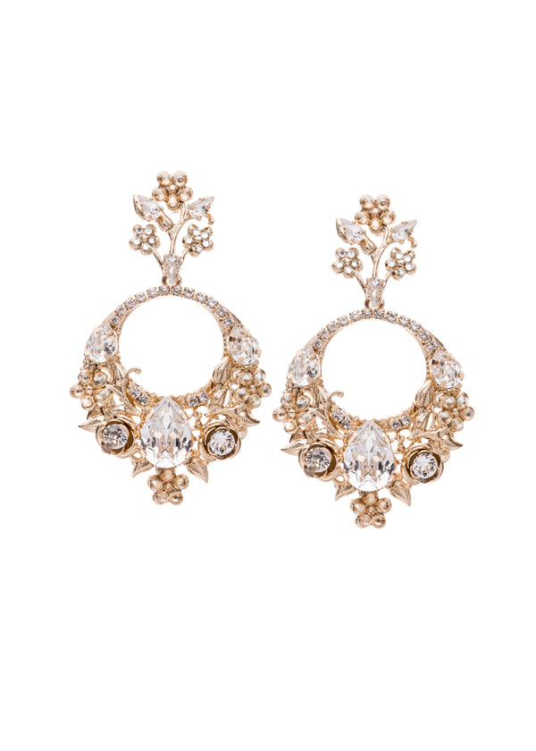 Pair of ornate earrings with floral designs and clear gemstones on a white background